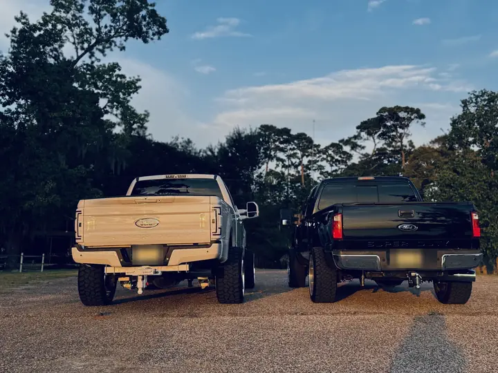 Paint-matched taillights and Gen-Y hitch on the 2017 Ford F-250 alongside a 2014 Ford F-250