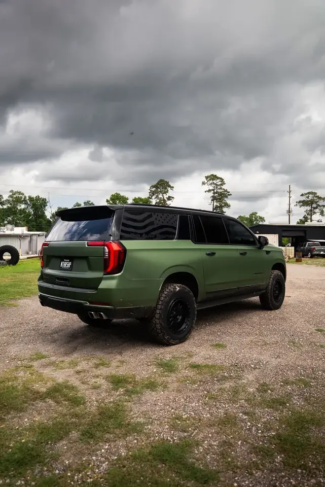 Rear three-quarter view of lifted 2025 GMC Yukon Elevation