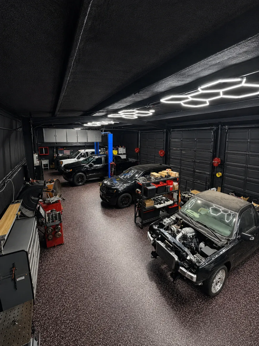 Unmatched Performance shop interior with trucks in service bays in Huffman Texas