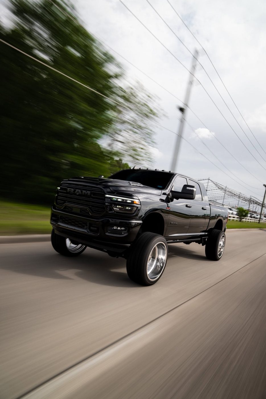 Lifted black Ram 2500 Mega Cab built by Unmatched Performance, rolling shot