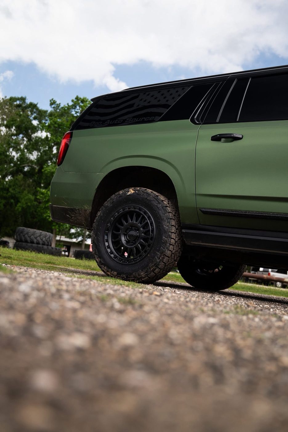 2025 GMC Yukon rear quarter and KMC wheel